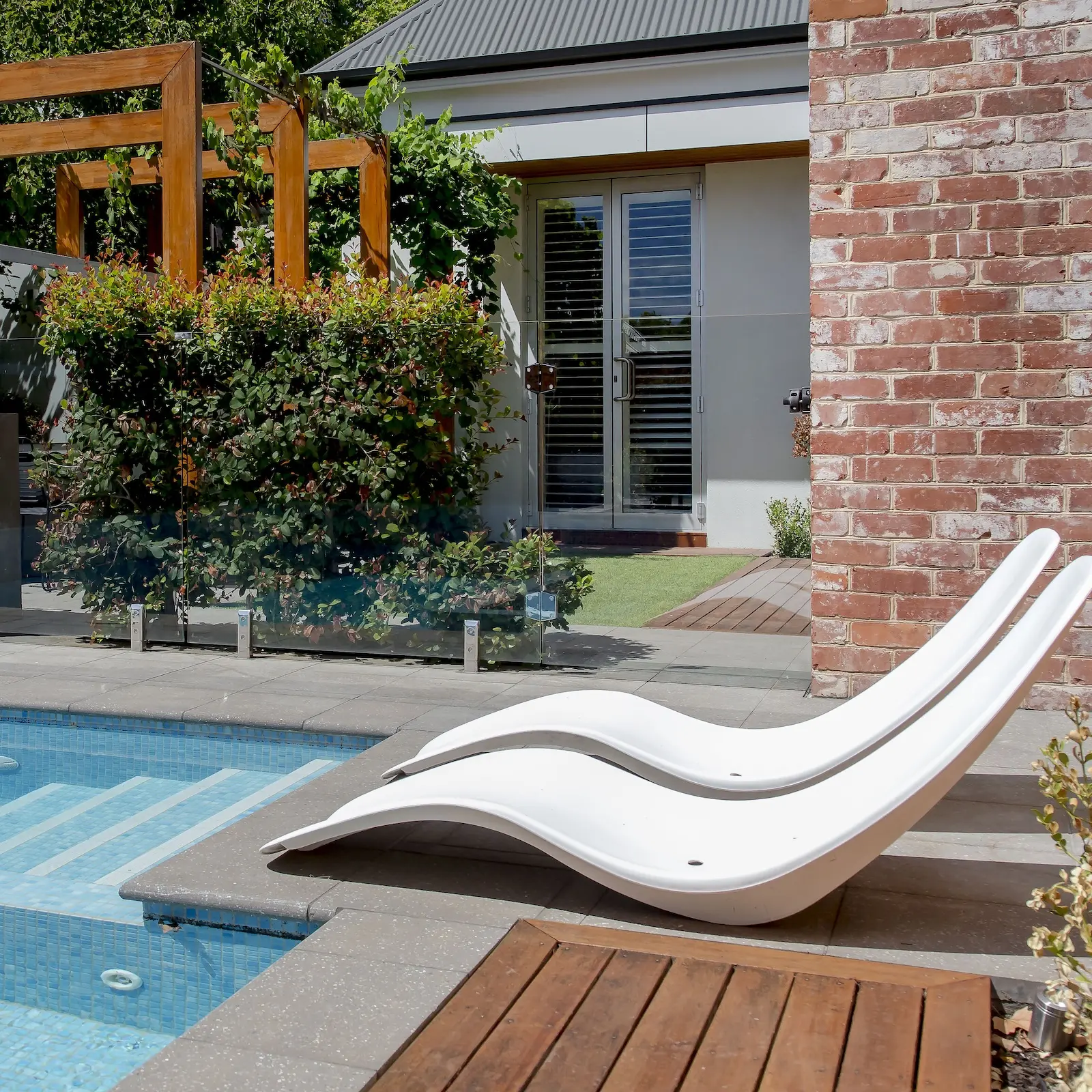 Shot of a property in norwood with a pool, chair, and decking.